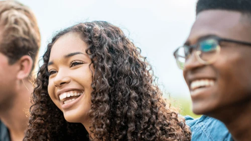 Photograph of teens in a line, smiling