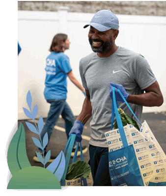 Volunteer at the CHA Revere Mobile Market helping with grocery bags