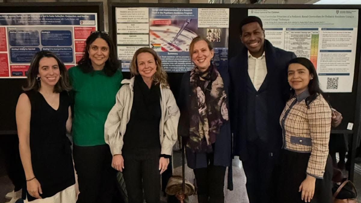 CHA staff members standing in front of a research poster