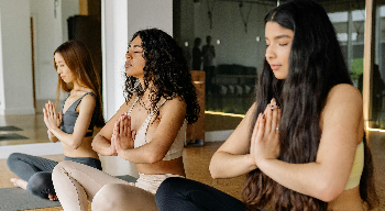 Three women in a yoga class