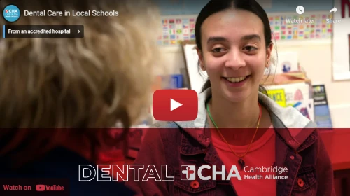 Video still of yound female with dentist in exam room