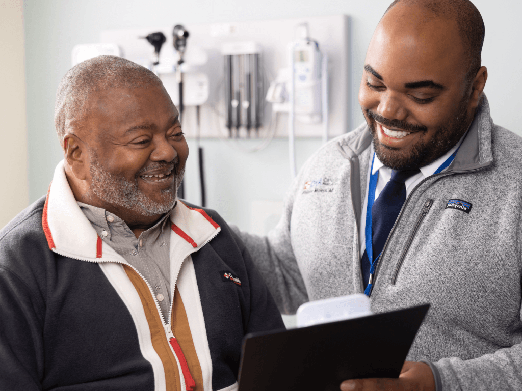 African American patient and Provider smiling during clinical visit