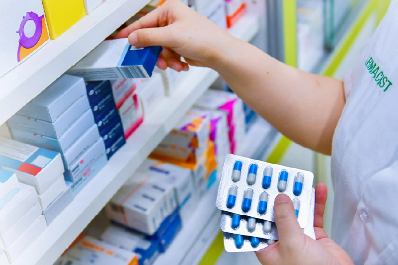 Pharmacist stocking shelves