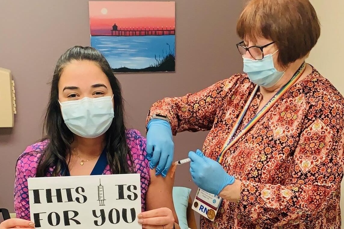 Patient getting a COVID-19 vaccine from CHA nurse