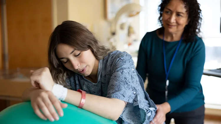 A CHA Doula helping a mother prepare for their birth in the hospital