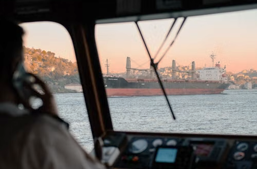 Photo of a commercial ship pilot navigating into a port