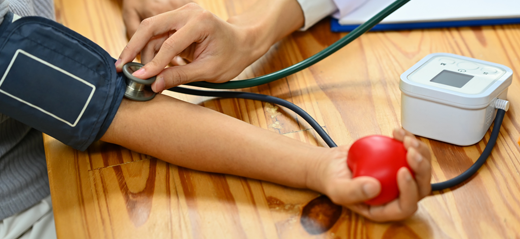 Pharmacist taking a patients blood pressure, just an image of their arms.