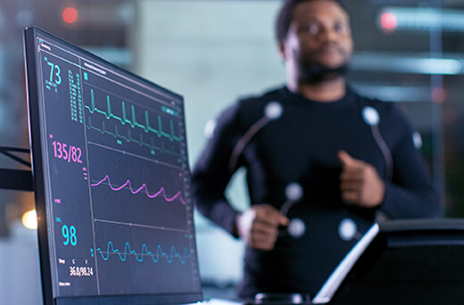 Man running on treadmill hooked up to diagnostic equipment